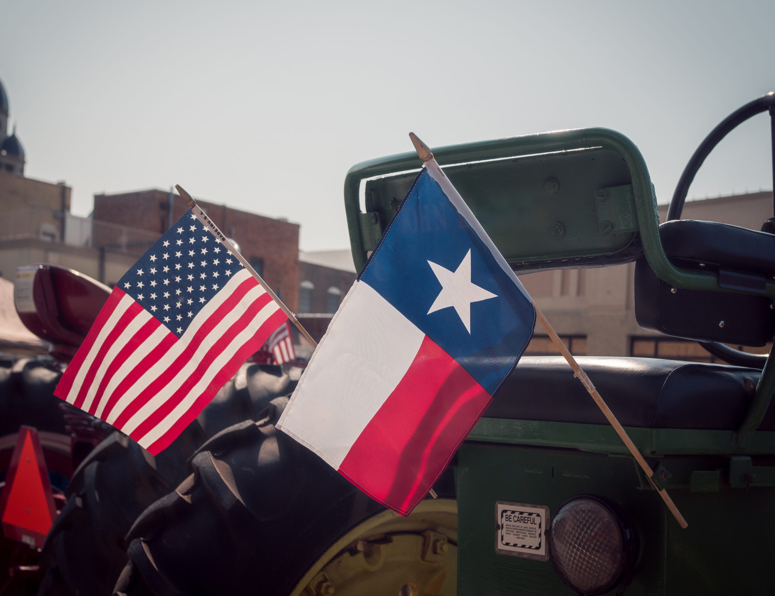 "Commercial semi-truck driving on Texas highway near urban skyline"
