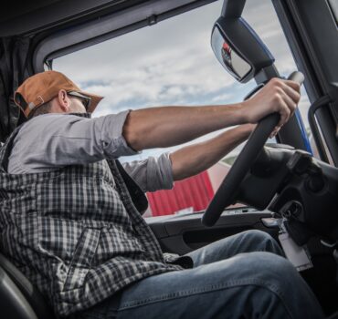 Truck driver operating a commercial truck safely during peak holiday freight season with focus on safety and risk reduction