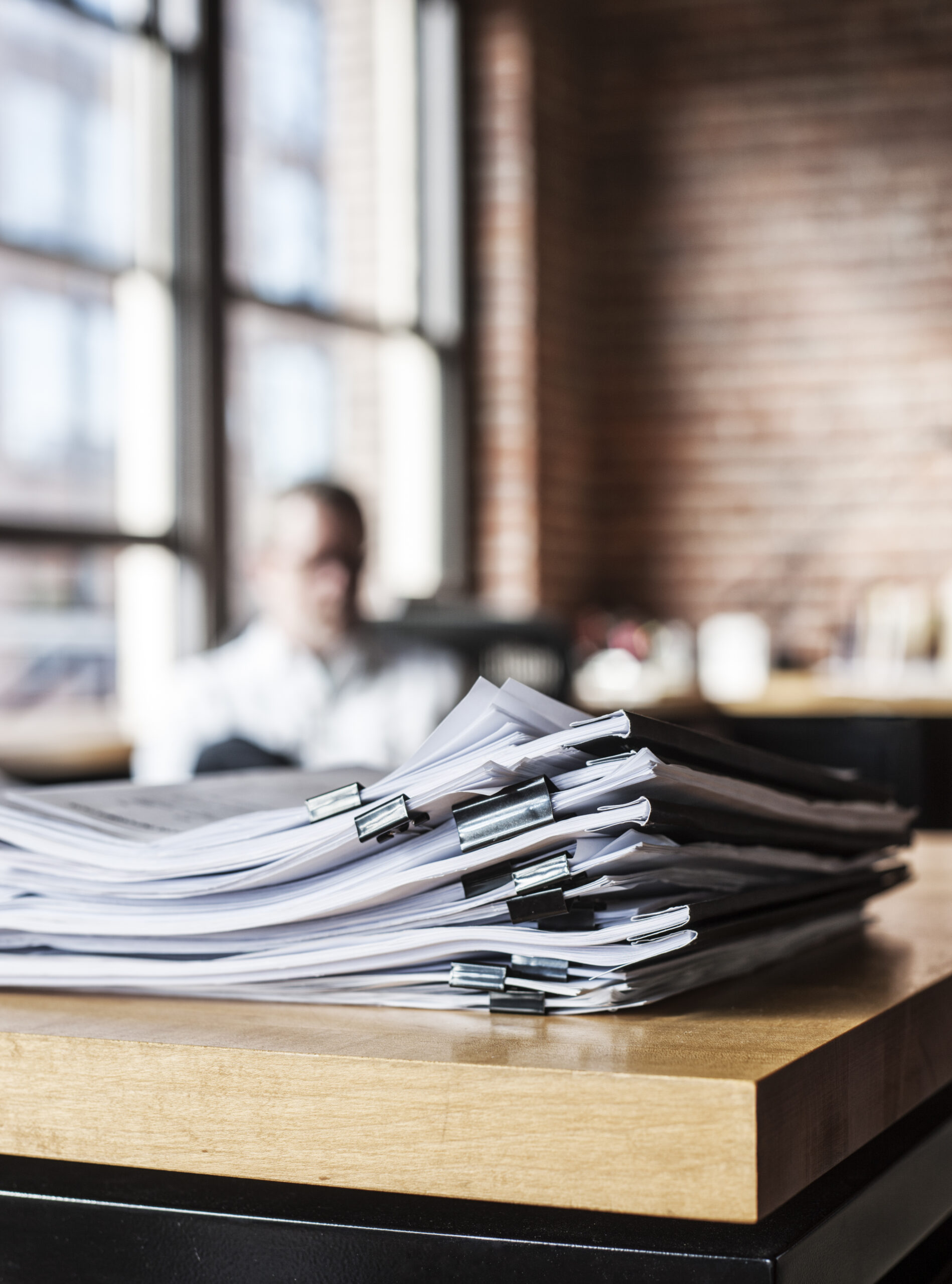 Fleet of commercial semi trucks parked at distribution center representing trucking insurance policy review