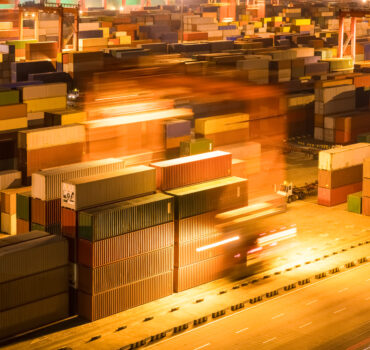Small fleet of semi trucks parked in yard representing trucking insurance coverage for fleets with multiple trucks