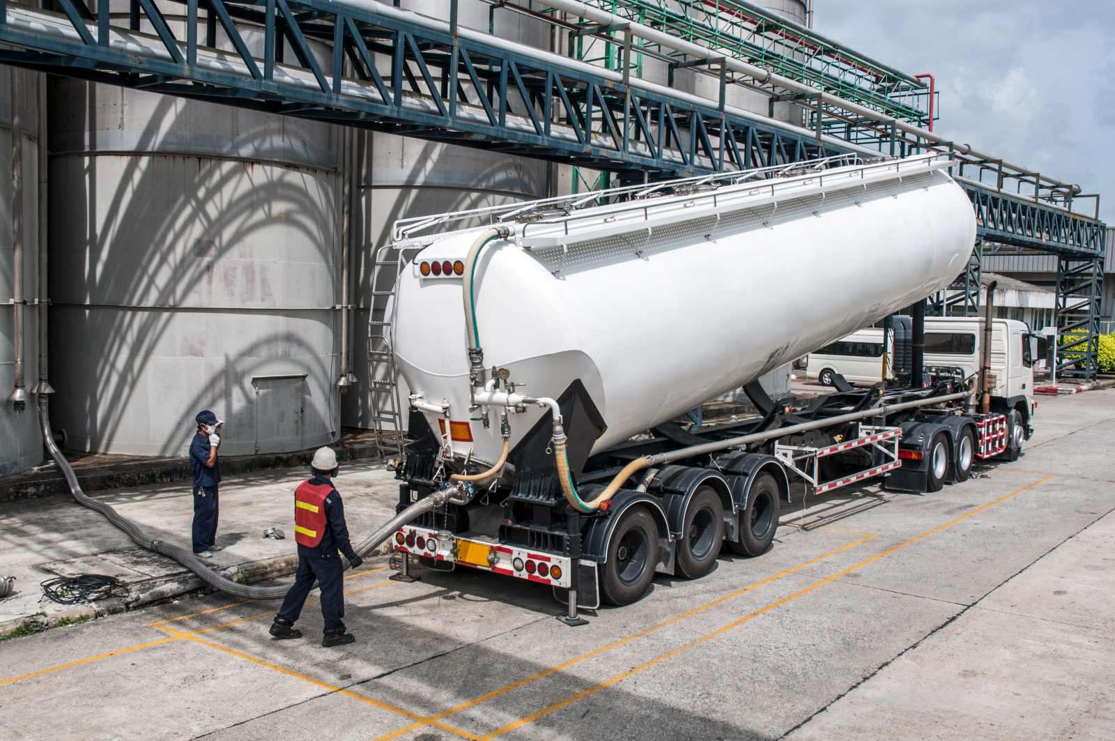 Hazardous materials hauling truck on the road with insurance requirements and cost-saving tips for hazmat carriers